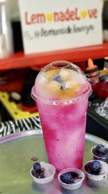 Our LemonadeLovely is blueberry topped with peach. Charcoal lemonade samples grace the tray