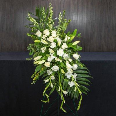 Radiance, a funeral easel spray designed with all white flowers.