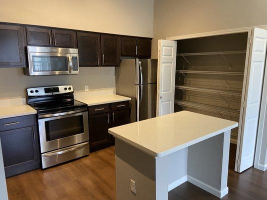 Kitchen of a unit at West Parc Apartments. Featuring large pantry storage space.