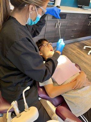 Flossing for my teenager who's in braces.