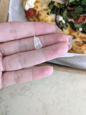 Bit into a hard piece of plastic on my pizza