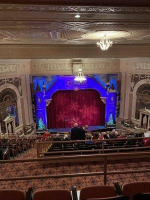 view of stage from balcony seats near the front of the balcony