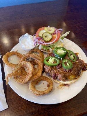 How can you resist homemade onion rings and homemade chili on the burger?