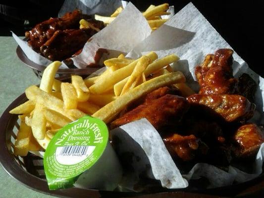 In the back ground Kianna's Cajun Honey BBQ wings (HOT) and in the foreground my Cajun BBQ Wings (HOT!). Seasoned Fries.