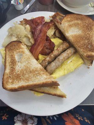 Eggs, bacon, sausage, home fries and toast.