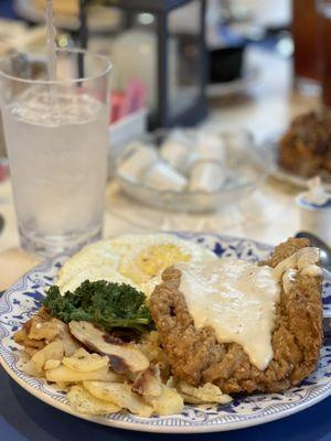 Country fried steak, fried eggs and homemade potatoes