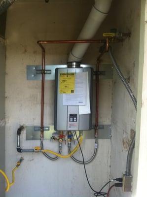 Installed a new tankless water heater where the old tank was located.