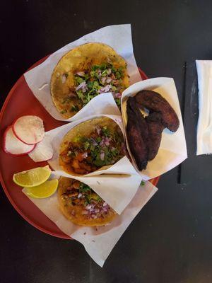 Carintas, Mexican style potatoes, and al pastor tacos with fried plantains.