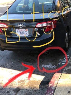 The shopkeeper threw these 6-pack rings in the gutter in front of his shop.