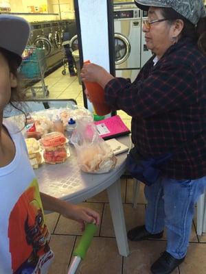 Nice lady selling chips and fruit.