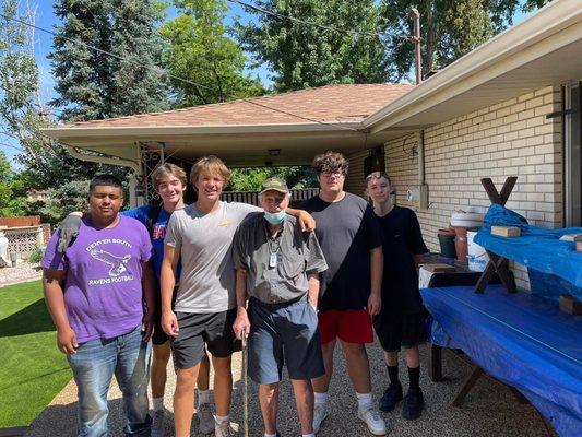 Some great volunteers from the South High Football Team with one of our members!