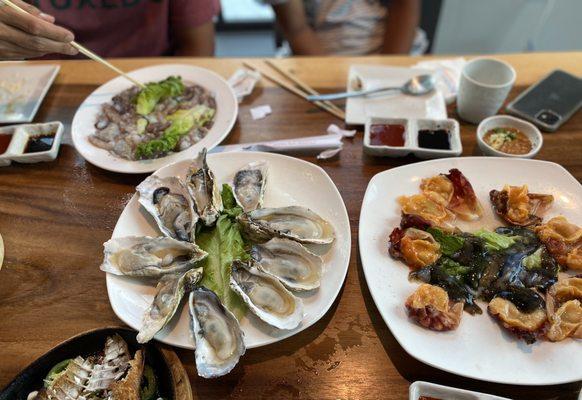 Live octopus (top), Oysters (left), sea squirt and sea cucumber (right)