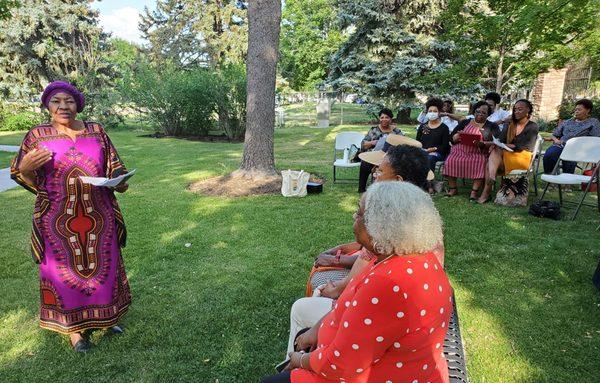 Charlotte Starks from Nubian Storytellers, welcomes the Community Vigil audience.