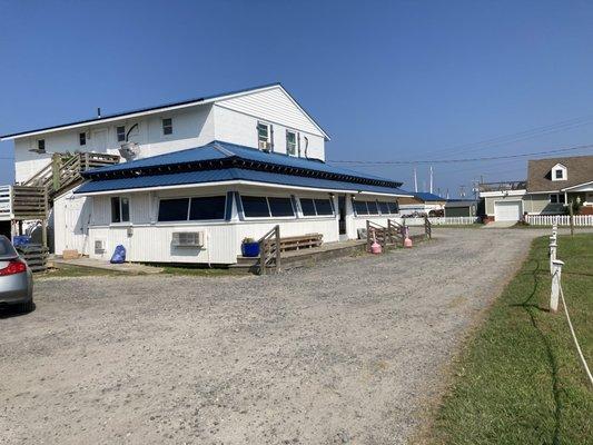 Front of Marina and Grill.  Grassy area includes picnic tables.