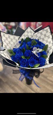 Wrapped floral bouquet with blue roses