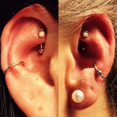 Multiple piercings in each ear done with rose gold titanium body jewelry and opal stones. Conch and rook