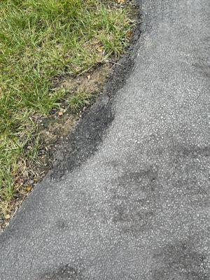 Crumbling driveway, after one year of a new pave plus seal coat as directed. Horrible workmanship.