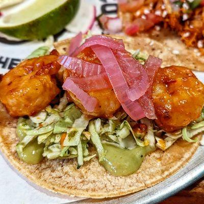 Spicy Shrimp: Sauted Shrimp in our Spicy Diablo Sauce. Served with Pickled Onions, Salsa Verde Slaw and Avocado Crema.