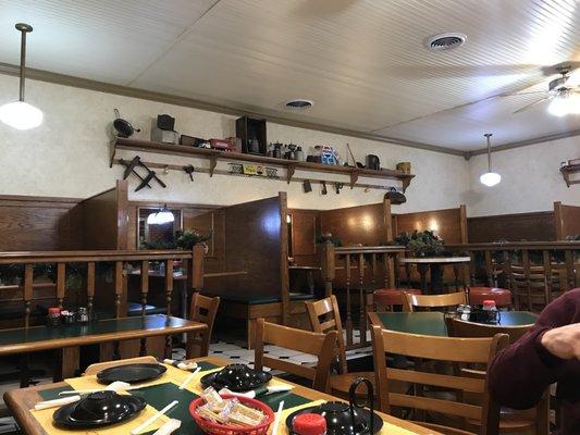 clean dining area, rich warm wood decor, and shelves of antiques