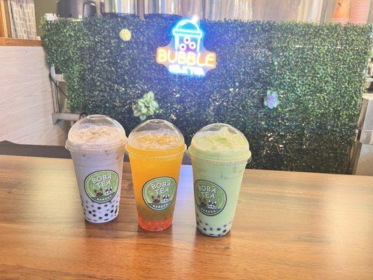 Taro milk tea with blueberry pearls, mango with strawberry and kiwi pearls, and honey dew milk tea with blueberry pearls