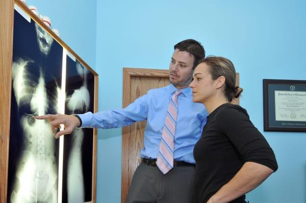 Dr. Breitbach explaining x-rays to a patient