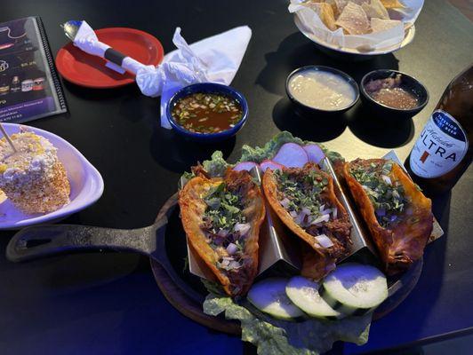 Birria tacos, elote, chips with queso and salsa