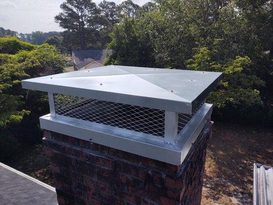 After full size custom galvanized cap with screen, covers multiple flues and covers cracked mortar on top of the chimney crown or wash.