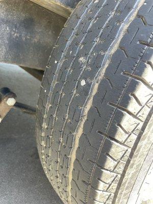 Nail in the driver side rear trailer wheel tire.