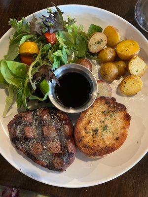 Beef filet, garlic toast, salad, and roasted potatoes