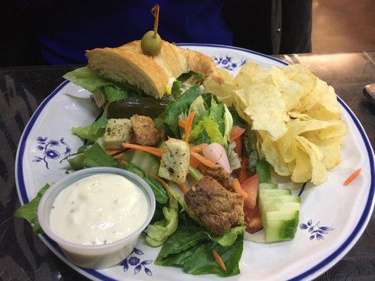 Chicken salad croissant with chips and salad