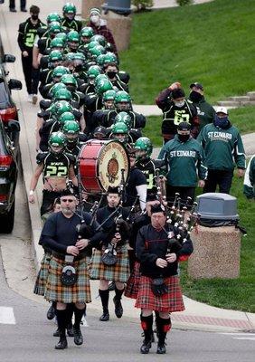 Marching the St Ed Green Wave onto the field