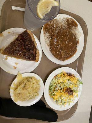 Seven layer salad, cabbage, ground steak and gravy with rice and a pecan pie for dessert oh yes and a cup of water with lemon