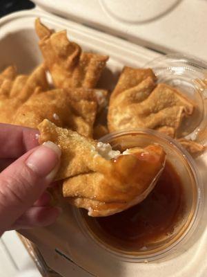 Cream cheese wontons with a lot of filling and slightly spicy sauce