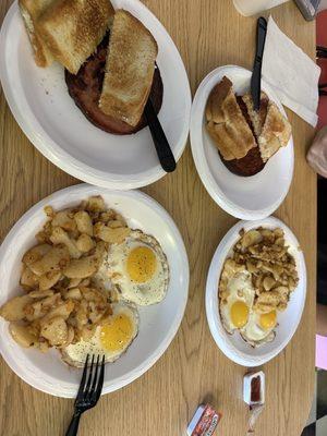 Two egg breakfast, home fries, meat (fried bologna) and toast.