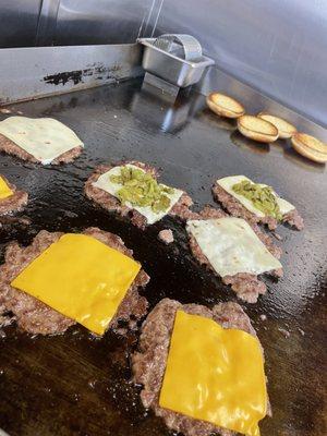 A few smash burgers on the grill during lunch at the Heavy Burgers food truck in Albuquerque.