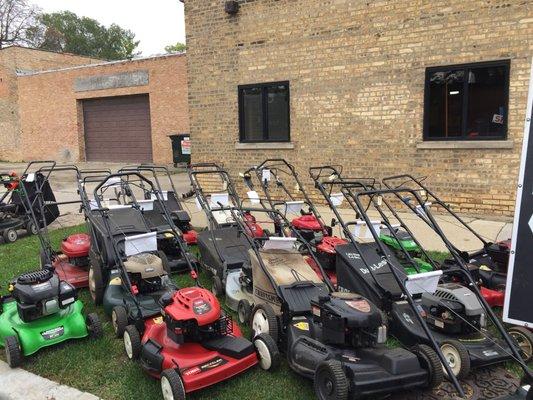 Used lawnmowers lines up outside