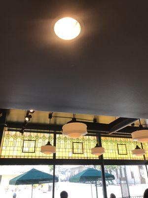 Beautiful stained glass windows line the ceiling at this Starbucks.