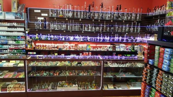 Water pipes on the shelves behind the displays. Hand pipes and pipe accessories in the displays.