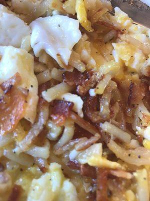 Eggs over medium hash browns scattered well. Bacon and a big mix and stir