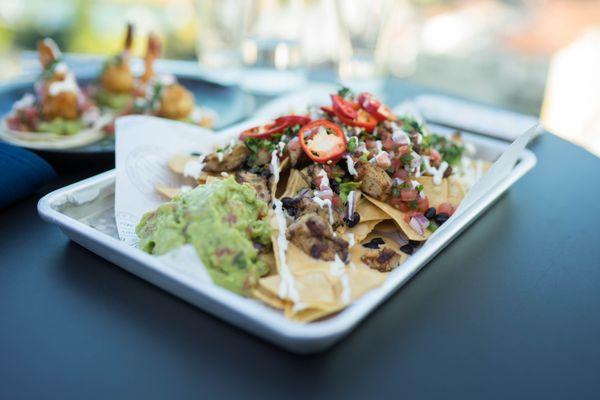 Mine, Not-Chos  House Fried Tortilla Chips, Queso Blanco, Cheddar, Pico de Gallo, Guacamole, Black Beans, Cilantro Lime Crema