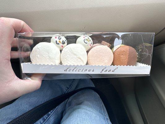 Macarons, container would hold 8 we got 4, cake pop snowman, pistachio and black currant. So delicious!