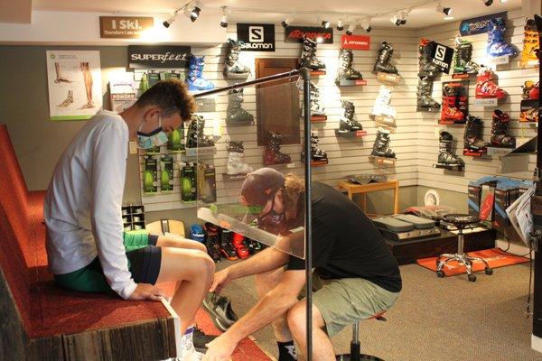 Plexiglass helps minimize direct contact, to make a safer boot fitting experience.