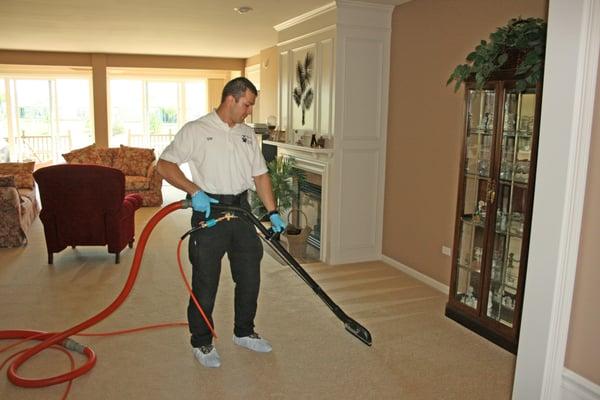 Our technician tackles the carpeting with our truck mounted hot water extraction system...