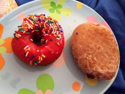 Cherry iced cake with sprinkles and chocolate filled glazed yeast doughnut. Sugar high!