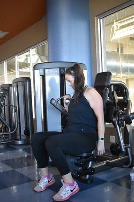 Woman doing curls on machine at Apex Centre