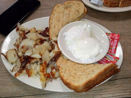 Perfect soft poached eggs with home fries and rye toast.