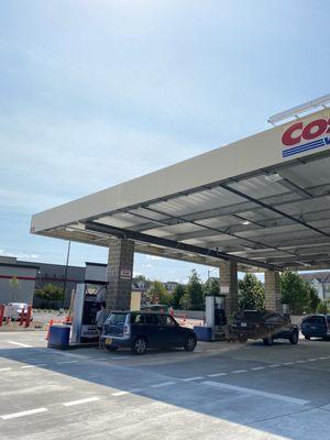 Gas station open behind store September 2021