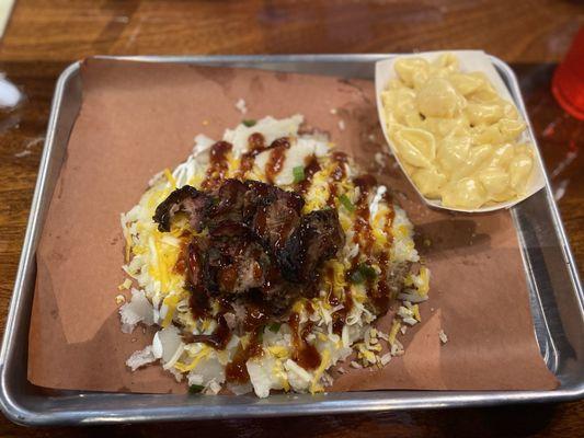 Brisket on smashed baked potato with side of mac and cheese