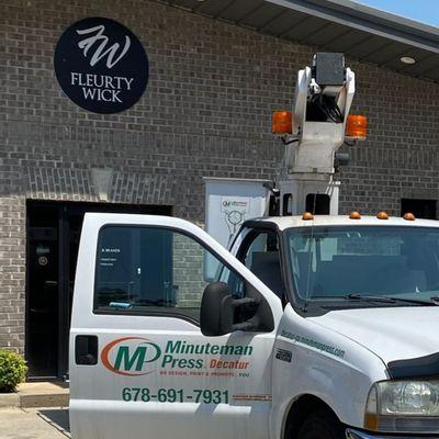 Minuteman Press in Decatur can reach 35 feet with our Boom Truck install our customer signs