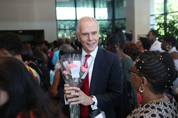 Attorney George Sink handing out Mother's Day flowers at the McDonald's Choir Showcase.